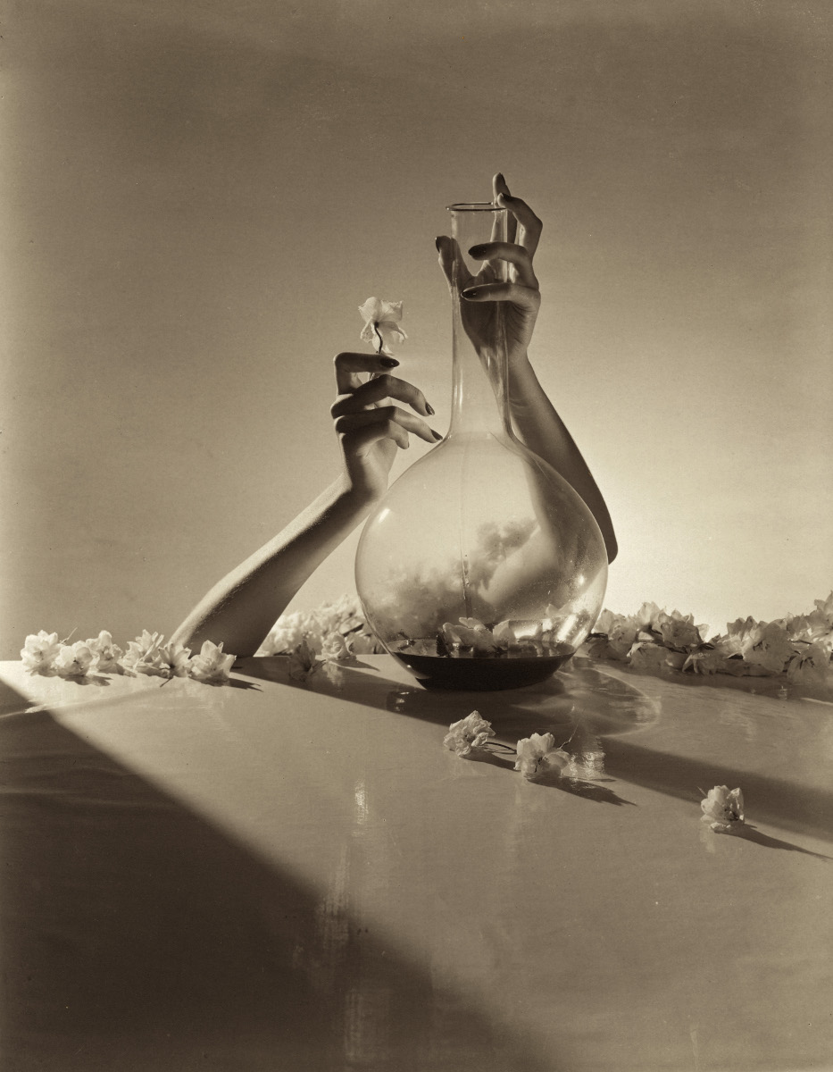 Hands with flowers and fiask - Horst P. Horst